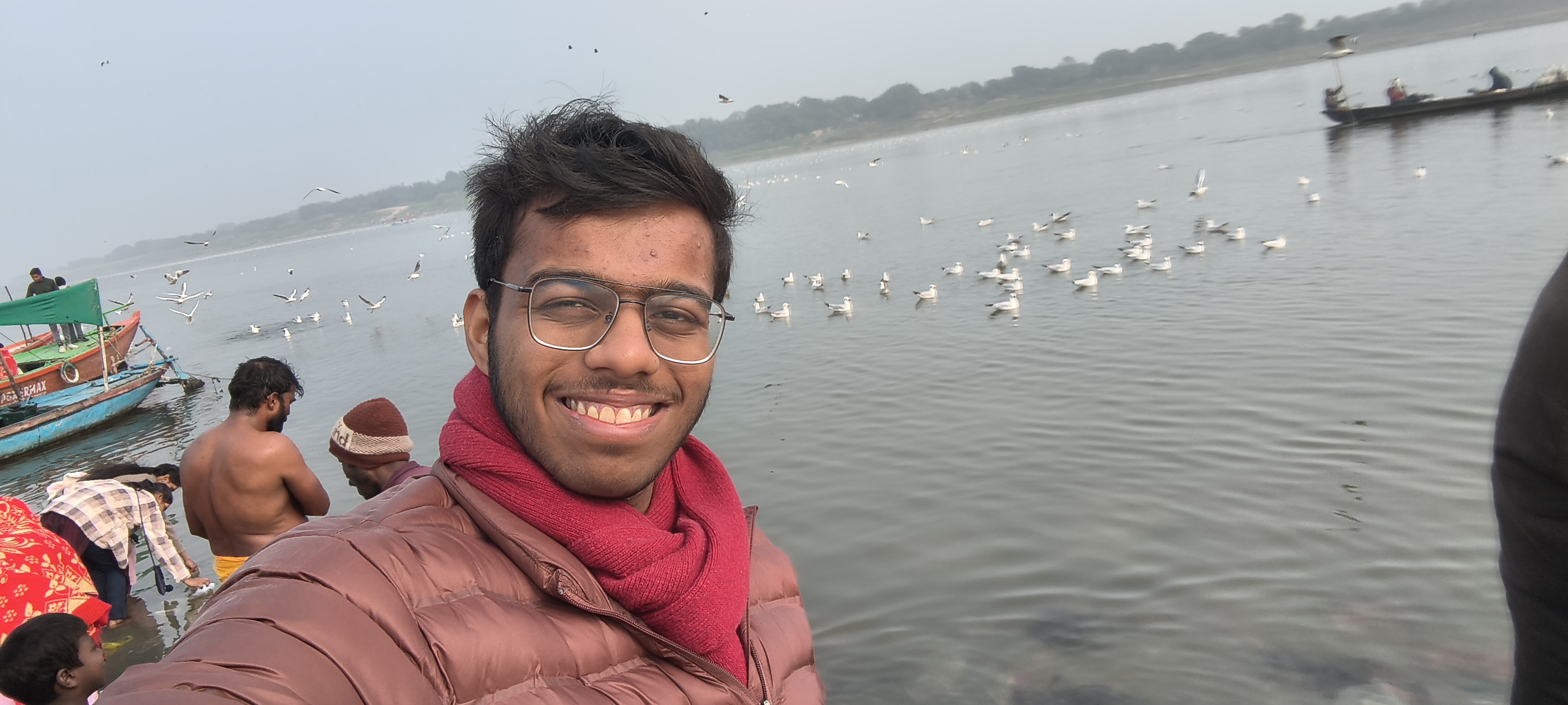 Ullas smiling beside the river on a winter morning